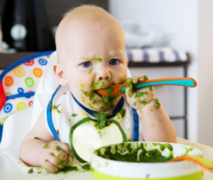 baby eating greens