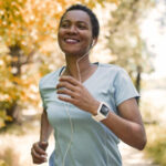 woman running outside with headphones