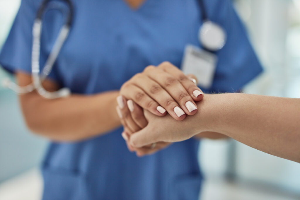 medical professional holding someone's hand