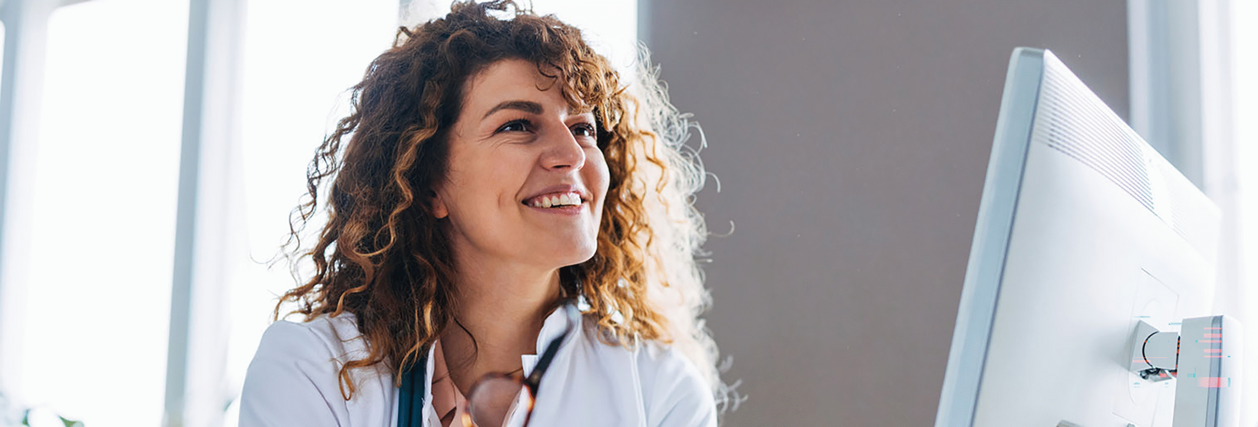 Female provider smiling looking across desk
