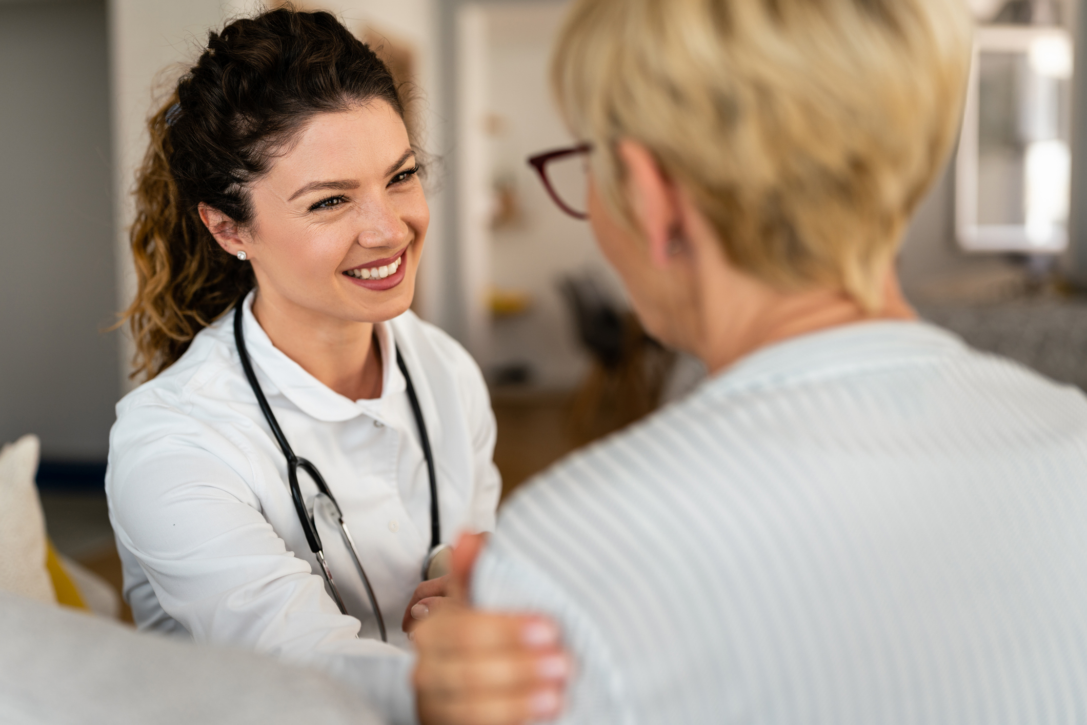 Female doctor caring for female patient.